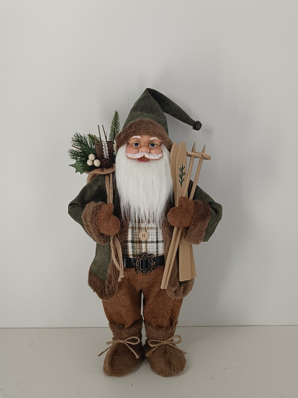 Santa Claus holding Gift Bag and Skiing Gear