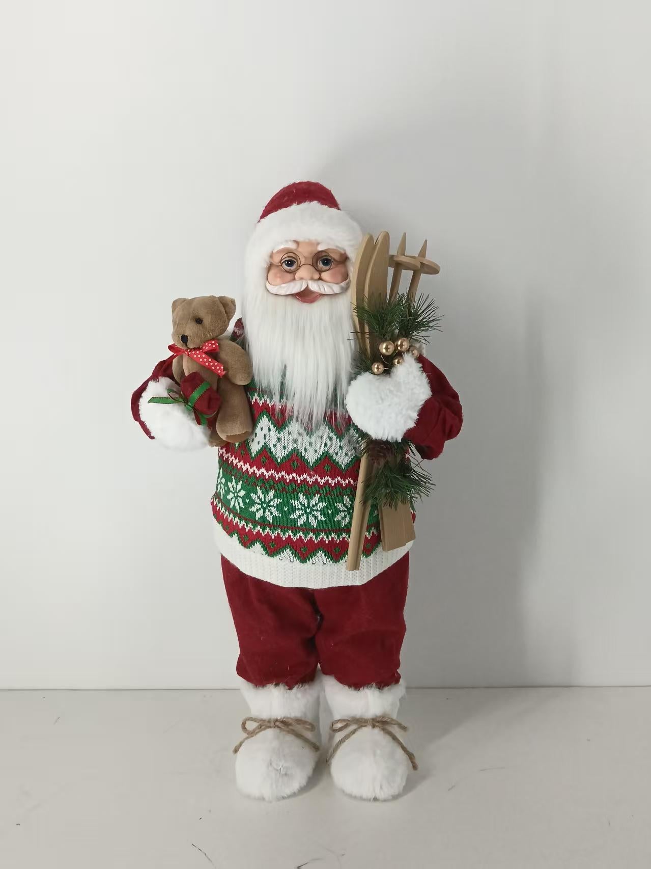 Santa Claus holding Teddy Bear and Skiing Gear