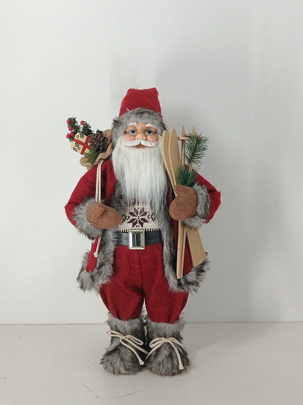 Santa Claus holding Gift Bag and Skiing Gear