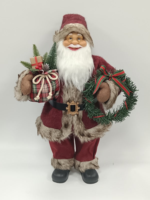 Santa Claus holding Gift Bag and Christmas Wreath